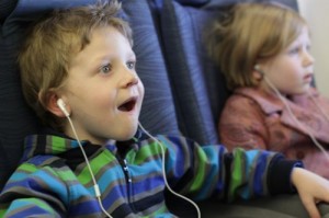 kids with earphones on airplane Blair Family
