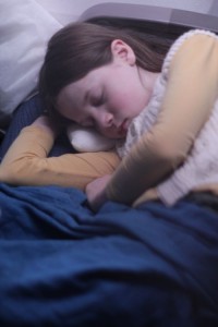 girl sleeping on airplane Maude Blair