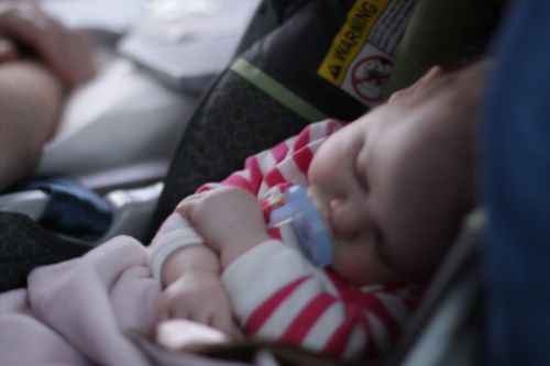 baby sleeping on airplane June Blair