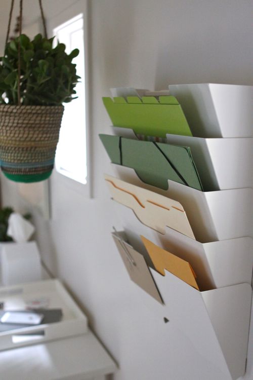 Magazine rack turned paperwork organizer. | Design Mom