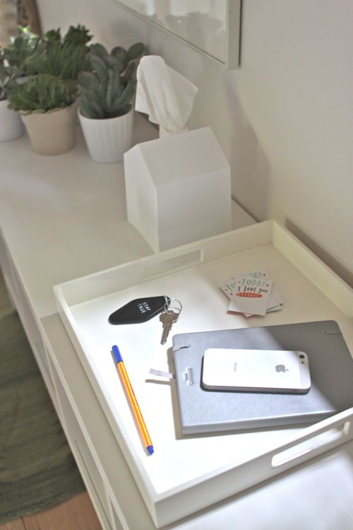 Use a tray for gathering cellphones, notebooks, keys, pens, etc. See the full Hallway Conversion on Design Mom.