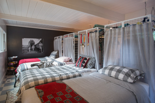 A shared bedroom for FOUR sisters. Freestanding closets separate the sleeping and dressing areas.