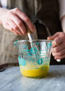 whisking sugar and egg yolks for creme brulee