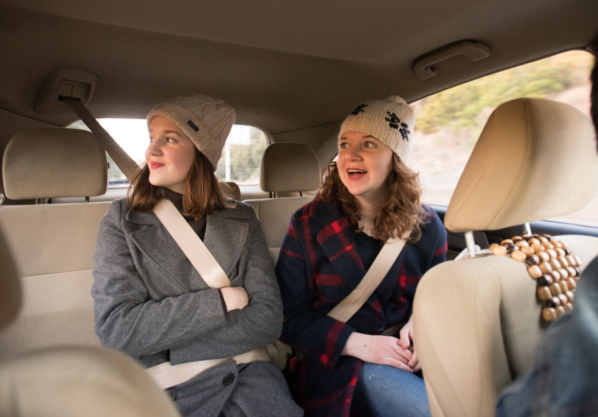 New Family holiday traditions featured by top US lifestyle blog, Design Mom: image of sisters riding their Uber